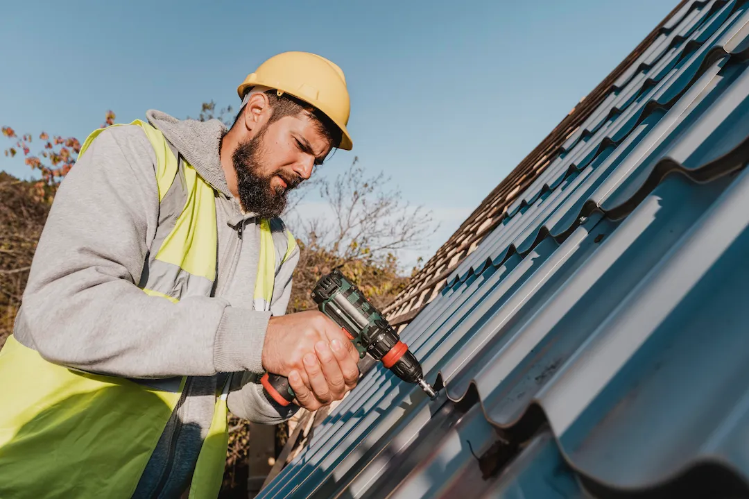 a man doing work on gutters with tools