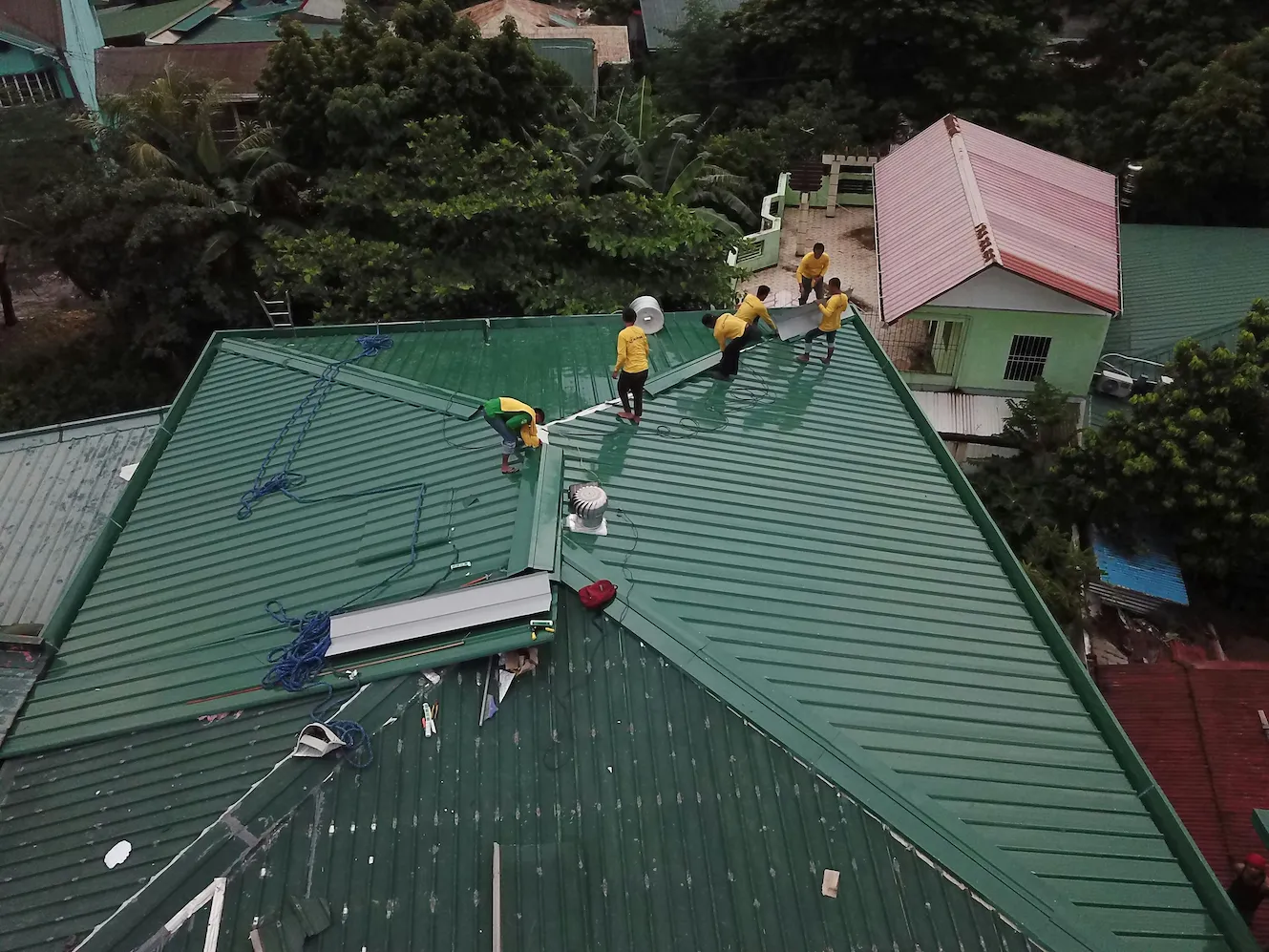 Our expert team members working on a roof cleaning service