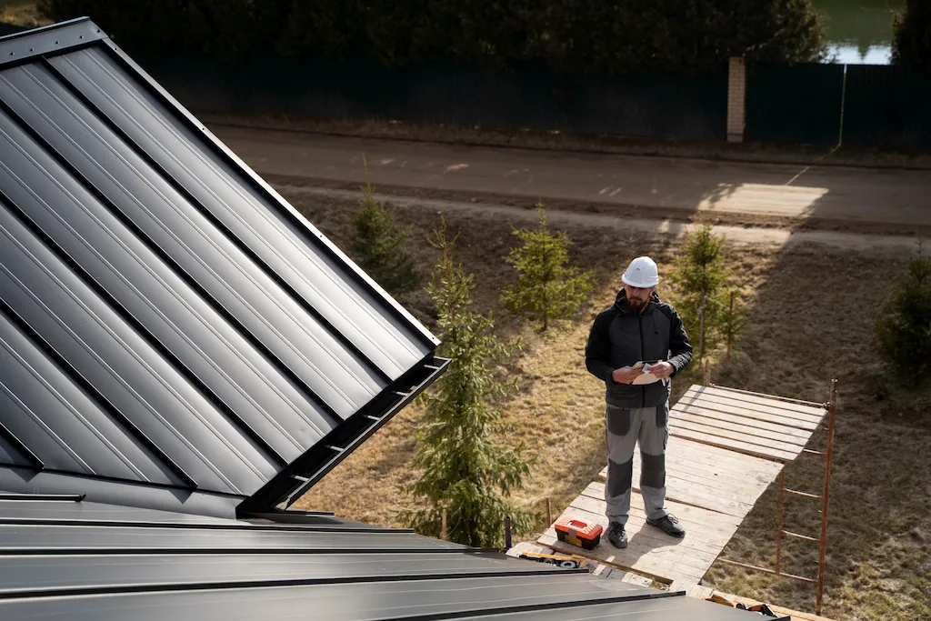 Standing in front of a house for inspection of gutters