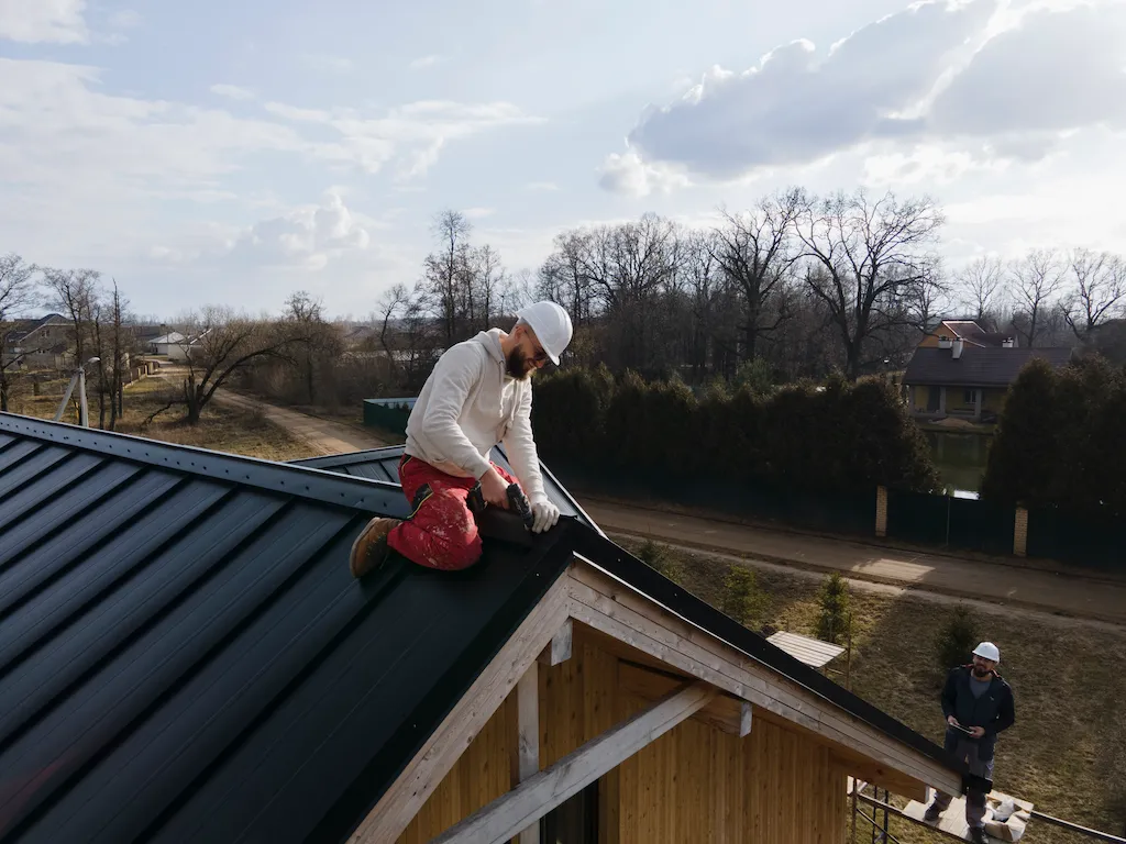 Installing the roof gutters of a new house in Glenorchy